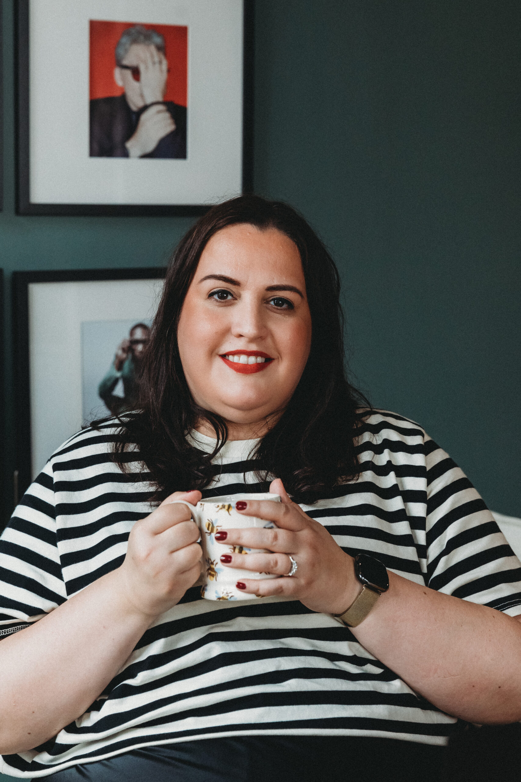 Alice smiling at the camera holding an Emma Bridgewater bee mug